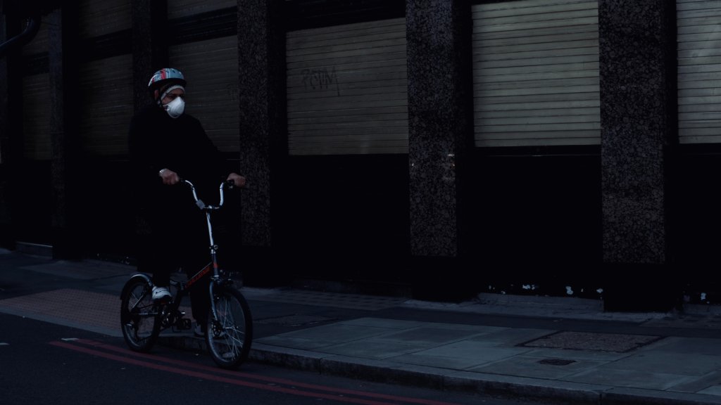 man in black jacket riding on bicycle