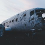 abandoned airplane on the floor under white clouds