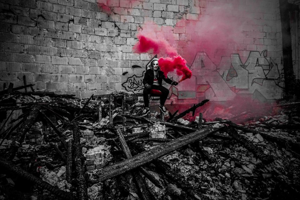 selective photography of person holding smoke with red color