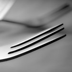 stainless steel fork on white paper