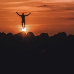 silhouette of person jumping in mid air