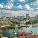 A cityscape view of Minsk, Belarus, shows historic architecture alongside modern buildings under a partly cloudy sky - Cover art/illustration via CryptoSlate.