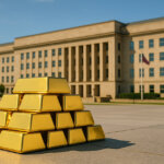 A bright, cinematic 16:9 photograph shows gleaming gold bars stacked on a sunlit stone plaza with the Pentagon’s beige facade and crisp blue sky in the background, balancing warm gold tones against cool blues and subtle greens.