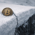 Bitcoin coin perched on a snowy cliff edge, symbolizing BTC holding the $62,000 support level as spot ETF flows turn positive while downside risk looms if the floor breaks