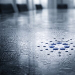 Cardano logo pressed into a misted boardroom table, symbolizing potential spot ETF filings by May as CME trading volume and regulatory deadlines come into focus