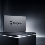 Tangem hardware crypto wallet card displayed on a pedestal with brand logo in the background, representing its security model, recovery process, fees, and supported assets in review