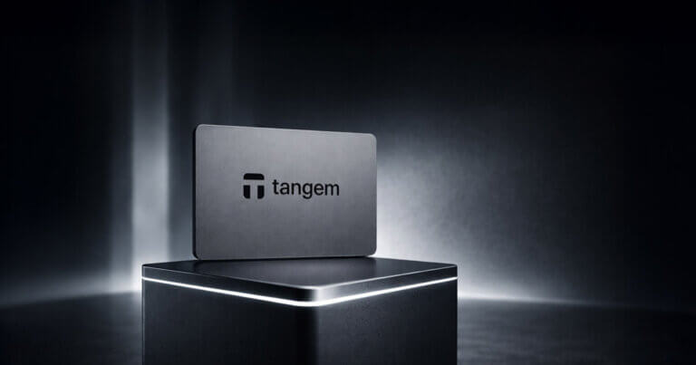 Tangem hardware crypto wallet card displayed on a pedestal with brand logo in the background, representing its security model, recovery process, fees, and supported assets in review