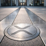 XRP logo embedded in a polished financial plaza floor leading toward a modern office building, symbolizing Ripple’s expansion into Wall Street’s stock-clearing system and XRP payments platform