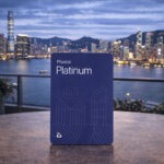 Blue platinum crypto card displayed against a city skyline at dusk, representing the Bing crypto card review