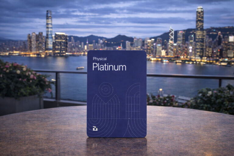 Blue platinum crypto card displayed against a city skyline at dusk, representing the Bing crypto card review