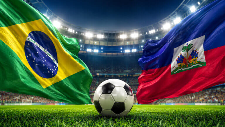 Soccer ball between Brazil and Haiti flags in a packed stadium, representing World Cup 2026 prediction market odds, match outcome probabilities, trading volume, liquidity and tournament signals.