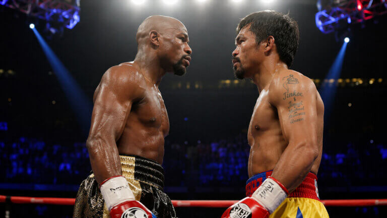 Floyd Mayweather and Manny Pacquiao facing each other inside a brightly lit boxing ring ahead of a potential rematch.