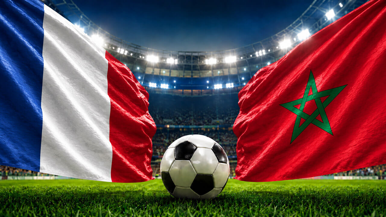 France and Morocco flags facing each other with a soccer ball at midfield inside a brightly lit football stadium