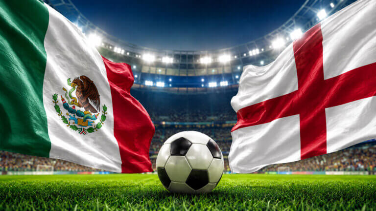 Mexico and England flags waving inside a brightly lit soccer stadium with a football centered on the pitch, representing a World Cup prediction market matchup.